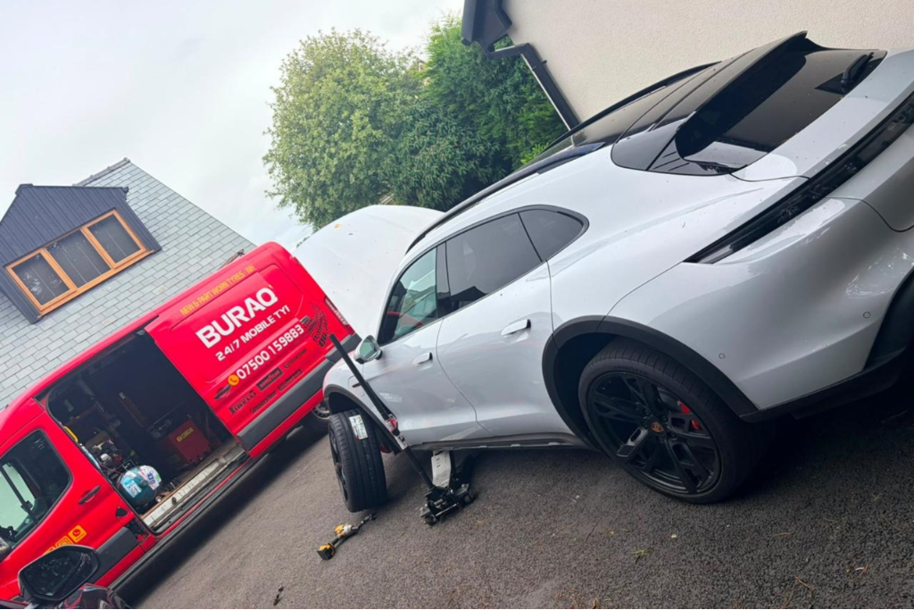 Buraq Tyres van fitting tyre on white Porsche in Clitheroe driveway