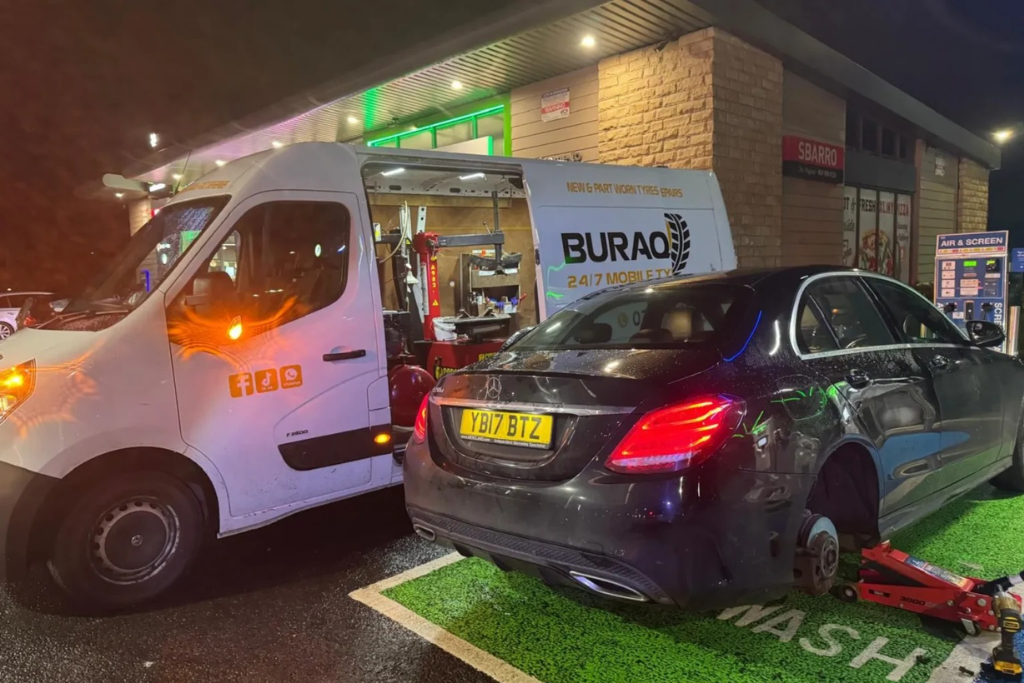 Buraq Tyres van beside Mercedes at night, Kirkham service station