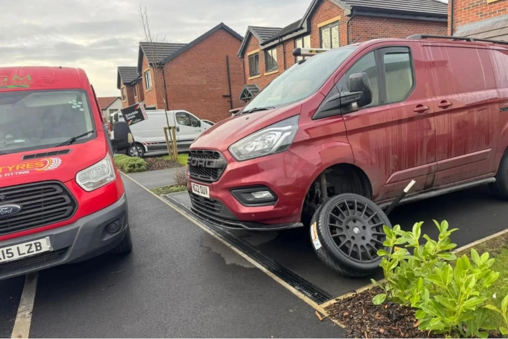 Mobile tyre fitting van beside Ford van with wheel removed, Longridge