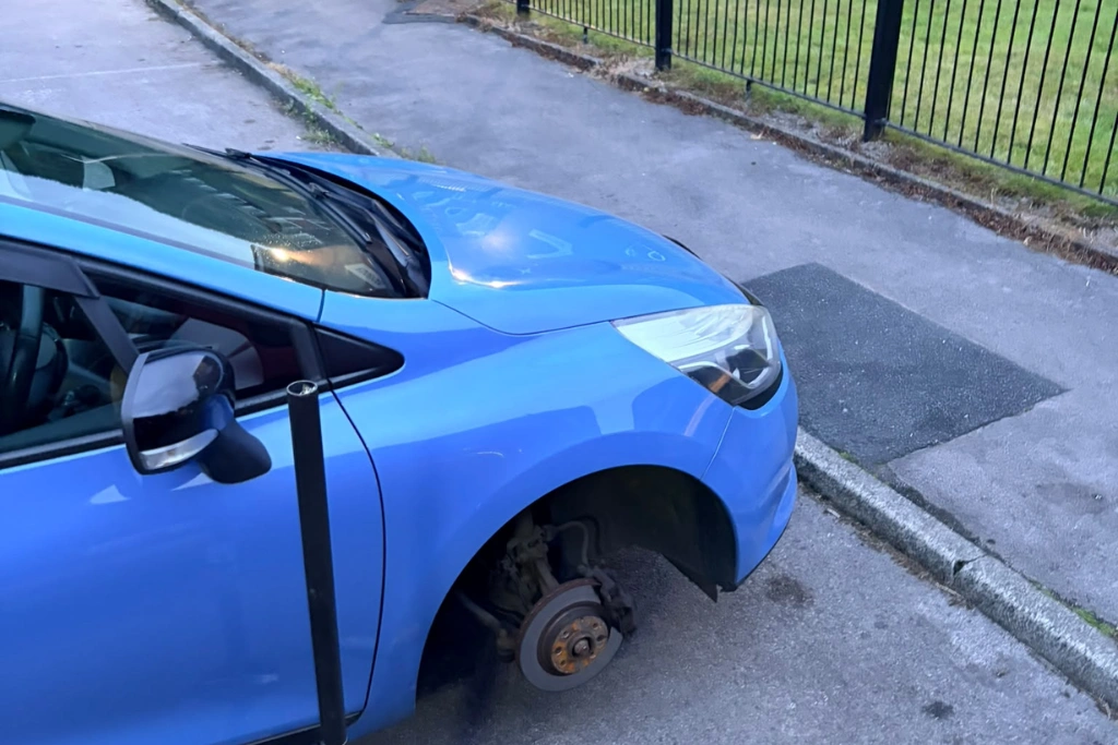 Blue car with front wheel removed for mobile tyre fitting, Accrington